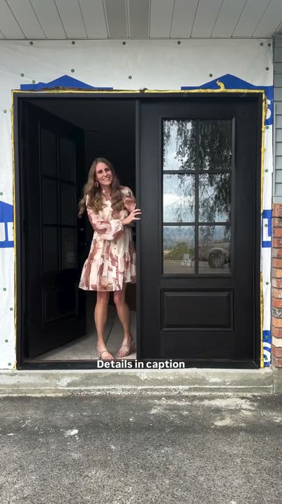 Reel by @howwedo208: Dark espresso front door with six glass panes on a grey house, a woman standing in the open doorway.
