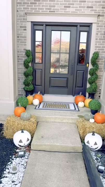 Reel by @SDOTDIY: Black front door with glass panes and sidelights on a brick house, a man sitting on the step.